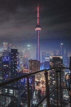 the city skyline is lit up at night