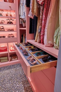 a pink closet filled with lots of clothes and accessories