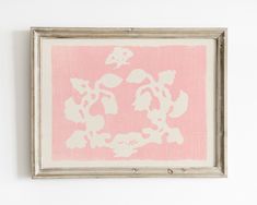 a pink and white painting hanging on the wall