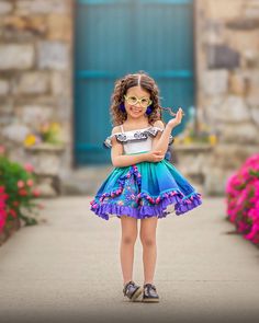 This Mirabel inspired dress is perfect for an encanto birthday or Mirabel costume. it  is all cotton. Features butterfly embroidered flounce with elastic along the shoulders. Sash in front of bodice is embroidered with colorful flowers. Skirt has several layers with ombré print over skirt with velvet trim, pink tassels and ruffle hem. Underskirt is floral print with purple eyelet lace hem. Full petticoat sewn into dress. Bottommost layer had a folded up you can pull apart to fully voluminize the skirt. Dress is fully lined with fully lined bloomers.  This is a pre order shipping mid July Mirabel Encanto Costume, Unique Kids Halloween Costume, Mirabel Costume, Encanto Costume, Encanto Dress, Encanto Birthday, Flamingo Costume, Encanto Party