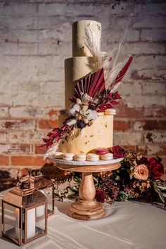 a three tiered cake with feathers on top