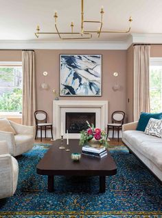 a living room with two couches and a coffee table in front of a fireplace