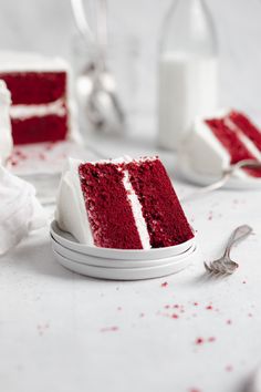 a slice of red velvet cake with white frosting