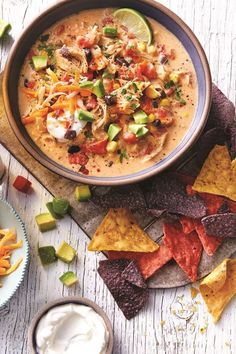 a bowl of quesadilla soup with tortilla chips on the side