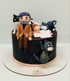 a cake with an image of a man surrounded by cats