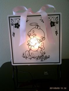 a lit up card with an angel on it