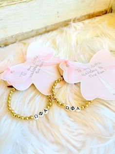 two personalized bracelets with name tags on them