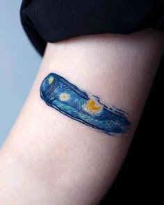 a woman's arm with a blue and yellow painting on it