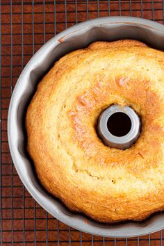 a bundt cake sitting in a pan on top of a cooling rack with a metal ring