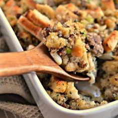 a casserole dish with stuffing and wooden spoon