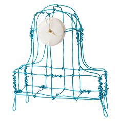 a blue wire bed with a white pillow on it's back and headboard