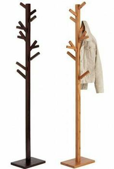 two wooden coat racks with coats hanging on them