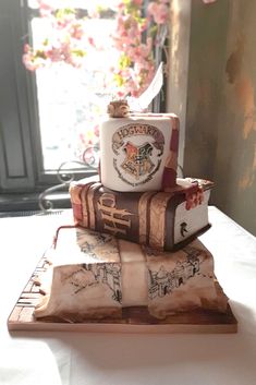 there is a cake made to look like harry potters books stacked on top of each other