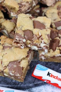 chocolate chip cookie bars stacked on top of each other with a candy bar in the background