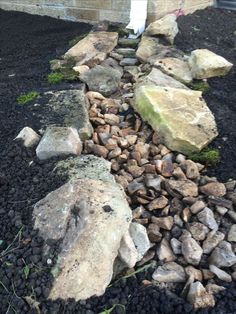 rocks and gravel in front of a house