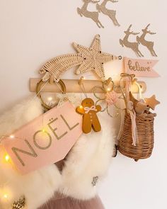 a wooden sign that says noel hanging on a wall next to some lights and decorations