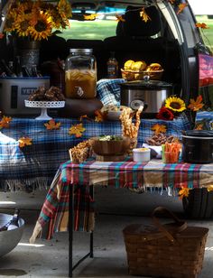 the back end of a van with sunflowers and other items in the trunk