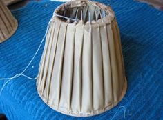 a lamp shade sitting on top of a blue blanket