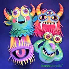 three brightly colored monster masks on a blue background