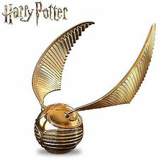 the golden harry potter statue is shown with its wings spread out and it's head tilted