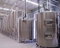 several stainless steel tanks in a large room