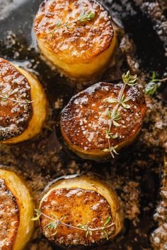 baked potatoes covered in powdered sugar and sprinkled with rosemary