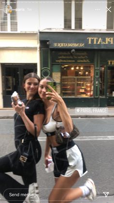 two young women taking a selfie on the street