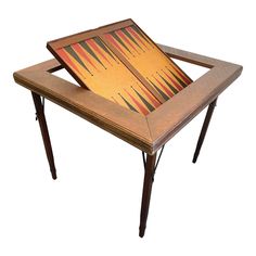 a wooden table with an abstract design on the top and legs, sitting against a white background