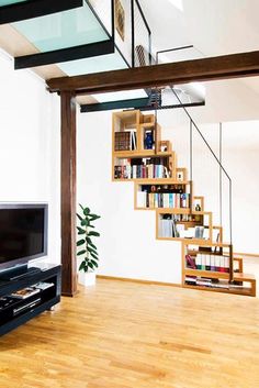 a living room filled with furniture and a flat screen tv sitting on top of a hard wood floor