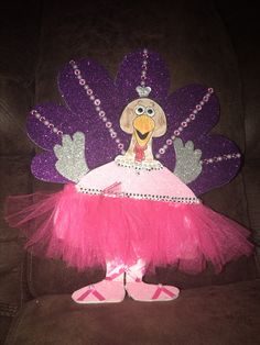 a pink tutu skirt with a purple turkey on it's head and feet