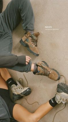 two people sitting on the ground with their feet propped up and wearing hiking boots, knee pads and leggings