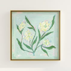 a painting hanging on the wall with flowers painted in pastel blue and yellow colors