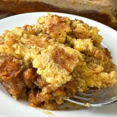 a white plate topped with food and a fork