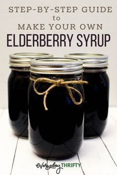 three jars filled with elderberry syrup sitting on top of a white wooden table next to a sign that says, step - by - step guide to make your own elderberry syrup