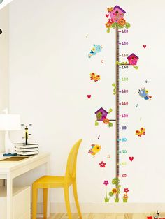 a child's growth chart wall sticker with birds and flowers on it in a room