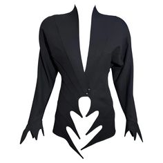 An extravagant jacket by Thierry Mugler from the Spring Summer 1989 "Les Atlantes" collection. This documented black jacket features a unique cutout pointed edge design. The jacket features a plunging neckline and has striped seaming that runs from the back and joins in the front. Batwing sleeves. Shoulder pads. Snap button front. Pointed edge cuffs. Size: FR36 Condition: Excellent condition Measurements: Bust- 36” Waist-26” Length- 30” Thierry Mugler Runway, Cutout Jacket, Mugler Runway, Oversize Collar, Ralph Rucci, Chanel Jacket, Thierry Mugler, Coat Design, Cashmere Coat