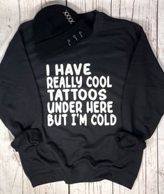 Cool Tattoos but I'm Cold Sweatshirt, Unisex sizing from S - 5X, Plus Size Tattoo Sweatshirt, Graphic Sweatshirt, 50/50 Cotton Polyester weighing 8 oz., Great Gift idea for any tattoo lover, Gift for Him or Her. Features ~ * 50% cotton, 50% polyester * Pill-resistant air jet yarn * Double-needle stitching throughout * Set-in sleeves * 1x1 ribbed collar, cuffs and waistband with spandex Our Process ~ We only look for the softness, comfy apparel that will withstand wash after wash. Decoration is m Funny Winter Streetwear Tops, Winter Punk T-shirt With Letter Print, Punk Style Letter Print T-shirt For Winter, Funny Black Winter Tops, Funny Black Top For Winter, Funny Winter Tops In Black, Funny Black Sweatshirt With Slogan, Black Funny Slogan Sweatshirt, Funny Black Slogan Sweatshirt