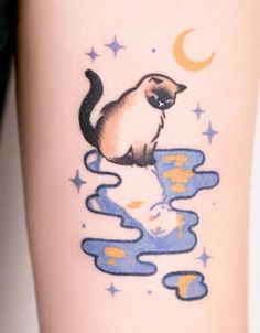 a cat sitting on top of a body of water next to a moon and stars