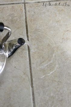 a pair of scissors sitting on top of a tile floor next to a knife holder