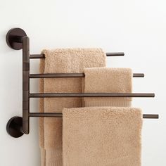 three towels are hanging on a towel rack