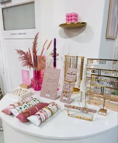 the table is set up with pink and gold accessories on it, along with other items