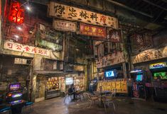 an indoor gaming room with arcade machines and signs on the walls that spell out chinese characters