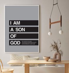 a poster with the words i am a son of god hanging above a dining room table