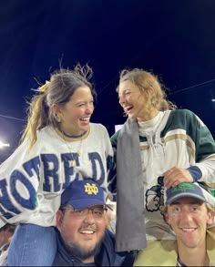 three people are posing for the camera at a sporting event