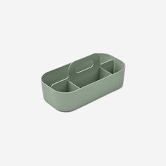 a green plastic container with compartments in it