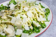 a white plate topped with lettuce and cheese