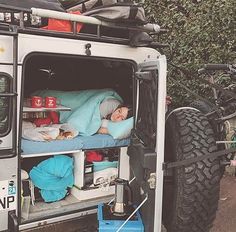 a person sleeping in the back of a truck