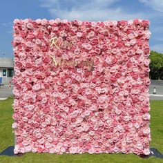 a large pink flowered wall in front of a building