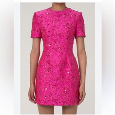 A Feast For The Eyes, This Statement Floral Dress Stands Out Among Our Hot Pink Dresses. It Features A Round Neck And Short Sleeves, Cinched At The Waist With A Slightly Flared Skirt And A Discreet Back Zipper. The Exquisite Cotton Blend Jacquard Fabric, Enhanced With Lurex, Lends A Luxurious Golden Sheen To The Floral Patterns, Accentuated By Sparkling Sequins For A Cute Yet Dazzling Touch. Perfect With A Blazer, This Meticulously Tailored Short Dress From Our Boutique Is Ideal For Elegant Dinn Glamorous Festive Dresses, Glamorous Festive Occasion Wear Dresses, Festive Glamorous Dresses, Elegant Jacquard Mini Dress For Party, Luxury Fitted Dress For Festive Season, Luxury Fitted Festive Dresses, Designer Pink Wedding Dress, Fitted Mini Dress For Festive Formal Occasions, Glamorous Jacquard Dress For Formal Occasions