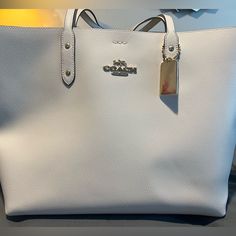 Coach Tote Bag Snap Closure Designer White Bags With Large Capacity, Elegant Shoulder Bag With Silver-tone Hardware For On-the-go, Designer Large Capacity White Bags, White Designer Satchel With Large Capacity, Rectangular Shopping Bag With Branded Hardware, Rectangular Shopping Bags With Branded Hardware, Modern Bags For Daily Use With Branded Hardware, Daily Use Double Handle Bag With Branded Hardware, Luxury White Bags For Errands